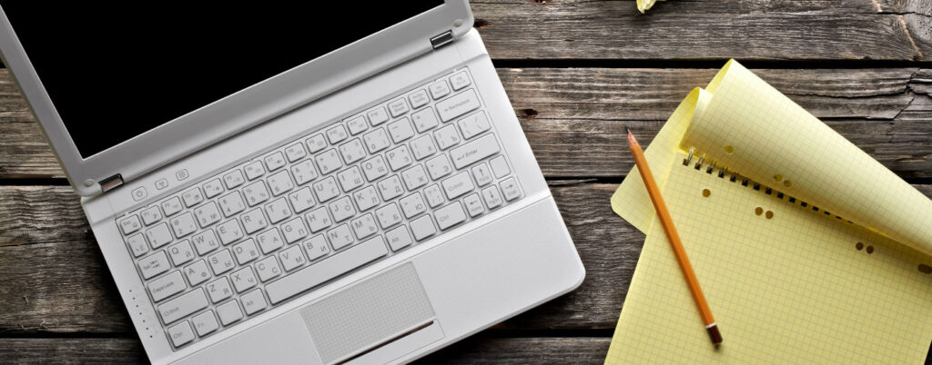 Modern ghostwriter typing on laptop in a cozy workspace